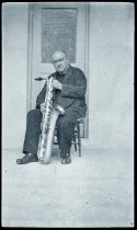 Father Ulrich Taube, SS.CC., with saxophone.